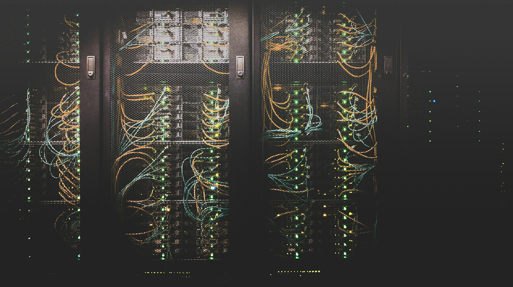 Server racks behind mesh doors in a data center