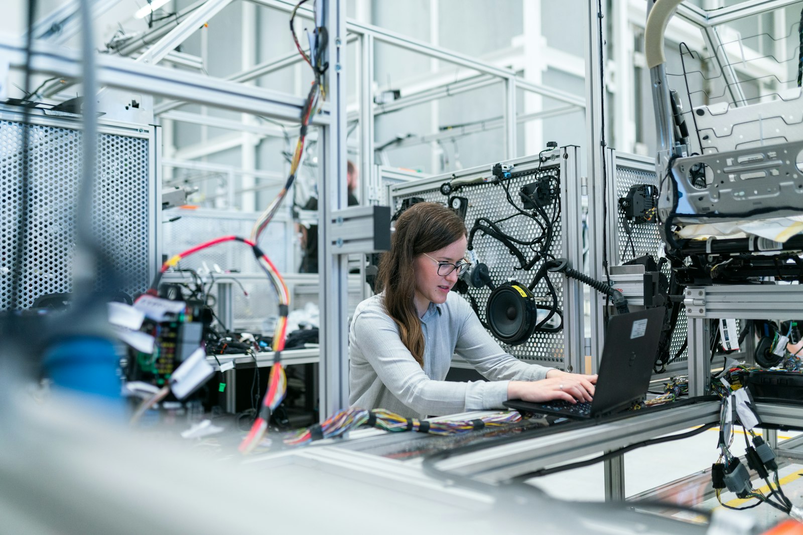 Engineer working among electronics assembly and test equipment